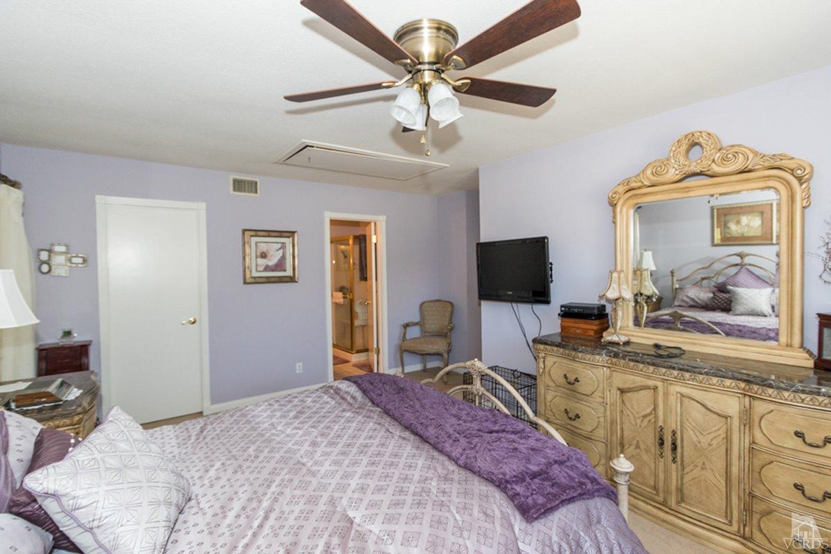 938 Erringer Road Simi Valley, CA 93065 - Photo 21 of 28 a bedroom with a bed and a flat screen tv