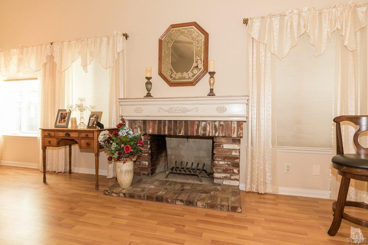 938 Erringer Road Simi Valley, CA 93065 - Photo 7 of 28 a living room with furniture a table and wooden floor