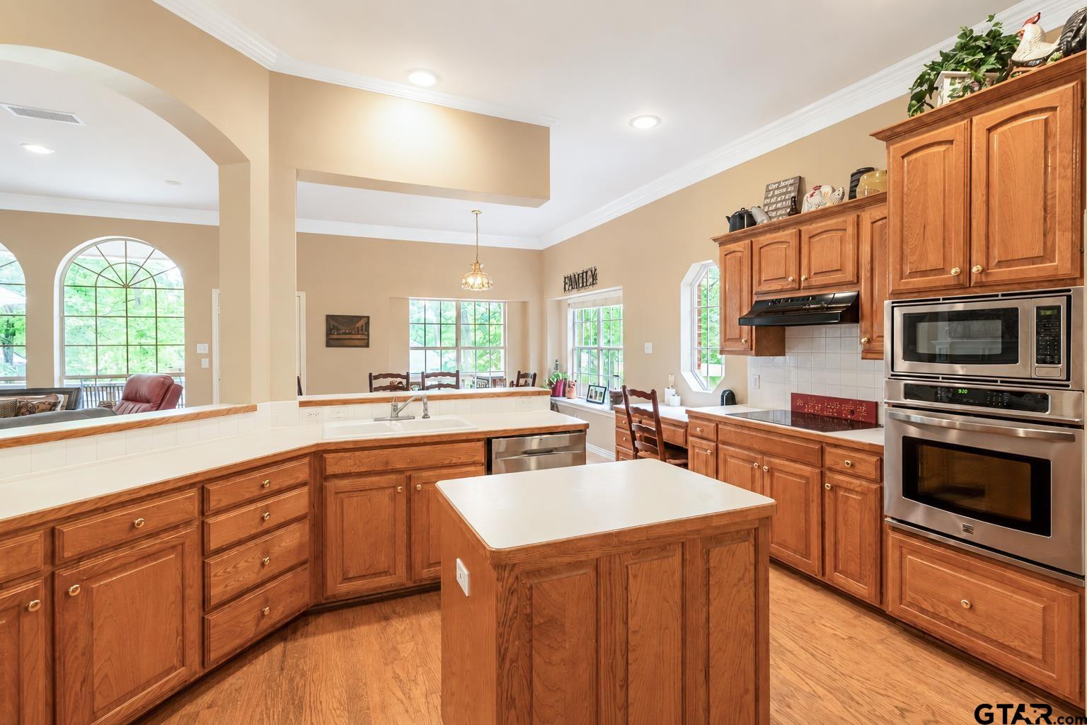 1388 Santa Fe Trail Tyler, TX 75703 - Photo 25 of 46 a kitchen with stainless steel appliances granite countertop a stove a sink dishwasher and a microwave oven with white cabinets