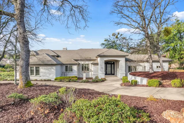 a front view of a house with a porch and a yard