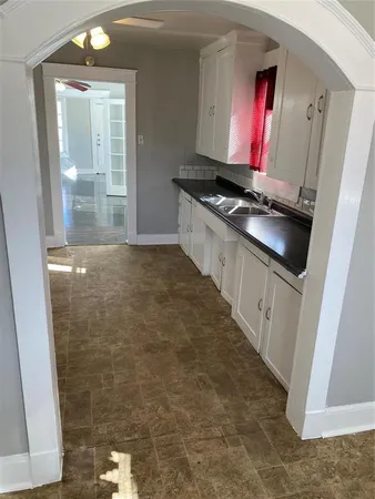 a kitchen with granite countertop cabinets and black appliances