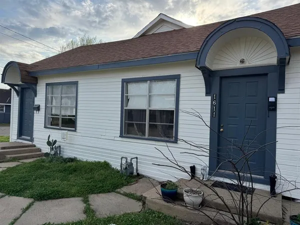 a backyard of a house with table and chairs