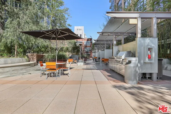 a view of a patio with table and chairs potted plants