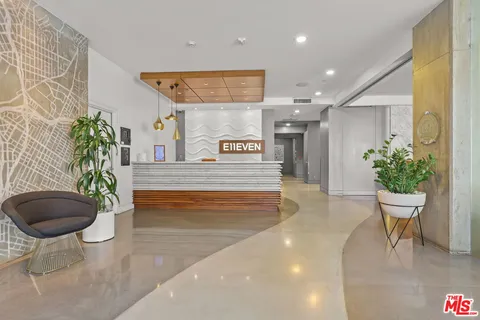 a lobby with furniture and a potted plant