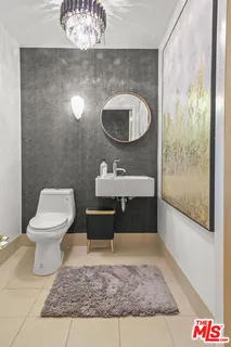 a bathroom with a sink toilet and a mirror