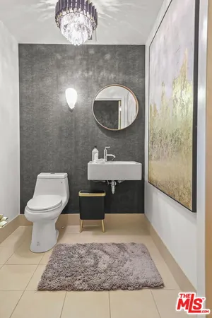 a bathroom with a sink toilet and a mirror