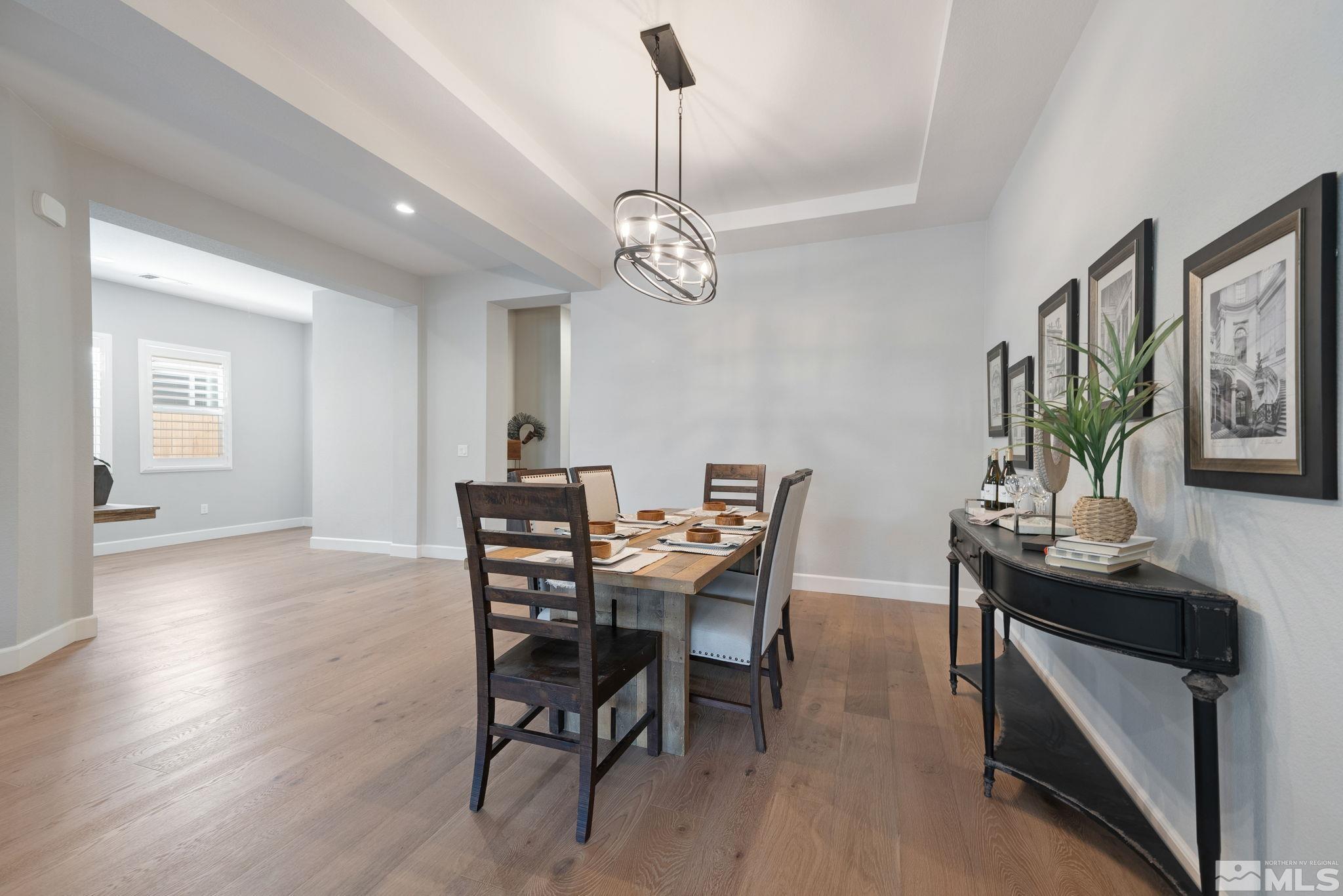 2450 Buttermere Court Reno, NV 89521 - Photo 11 of 39 a view of a dining room with furniture wooden floor and chandelier