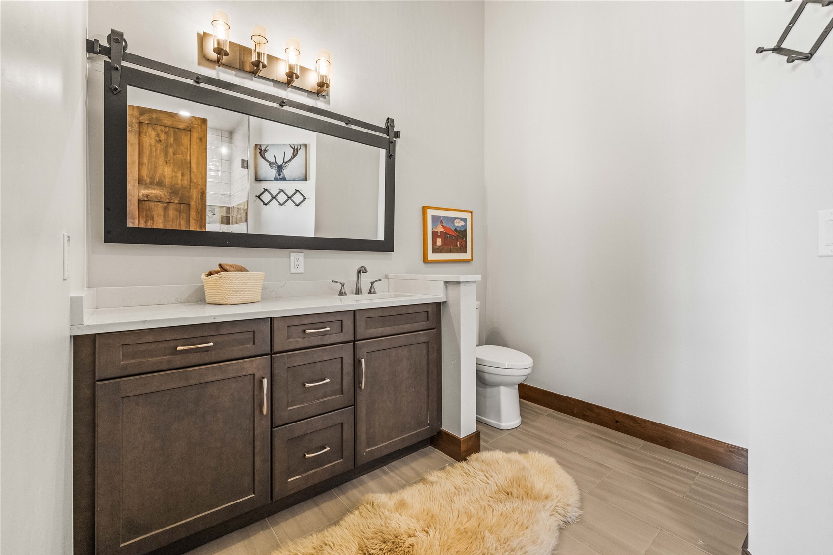 230 Game Trail Road Silverthorne, CO 80498 - Photo 37 of 43 a bathroom with a toilet sink and mirror