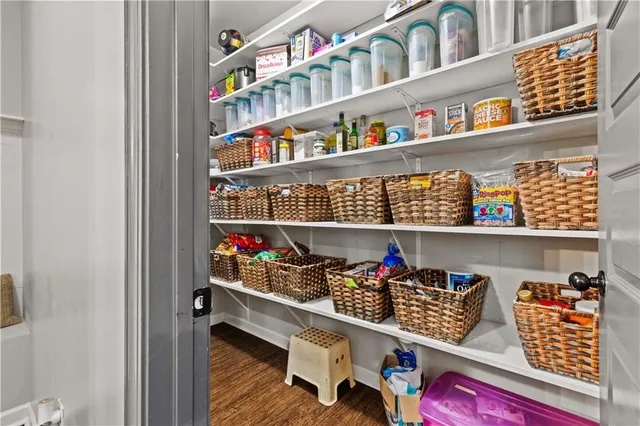 a room with lots of books and a shelf