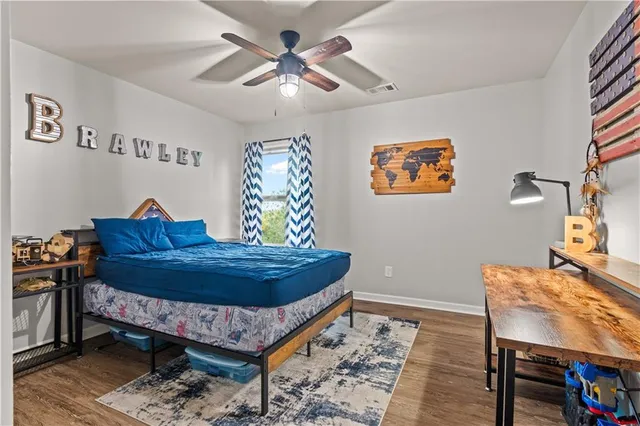 a bed room with a bed and a chair