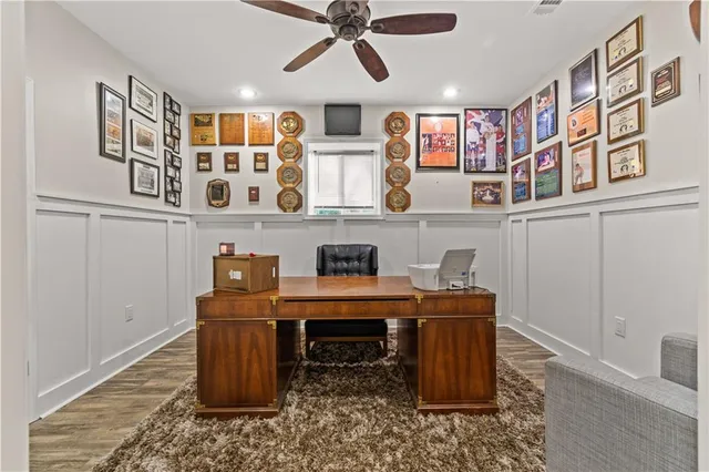 a view of a workspace with furniture and window