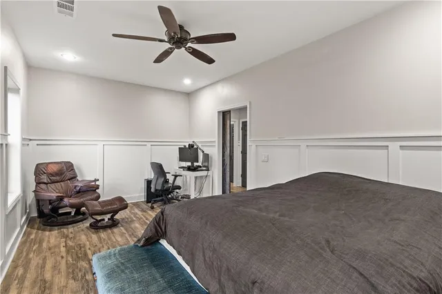 a bed room with a bed and a chair