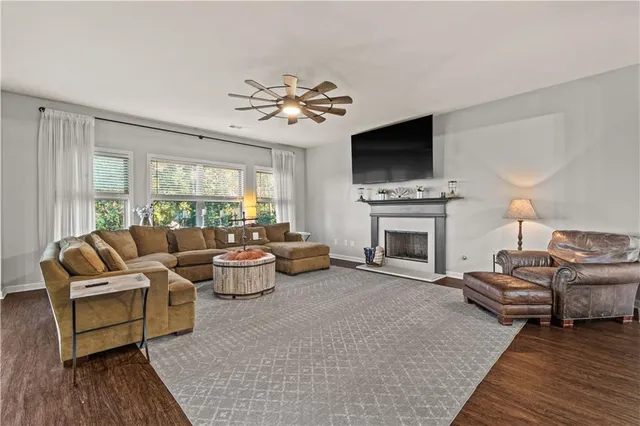 a living room with furniture fireplace and flat screen tv