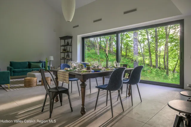a living room with furniture and potted plants