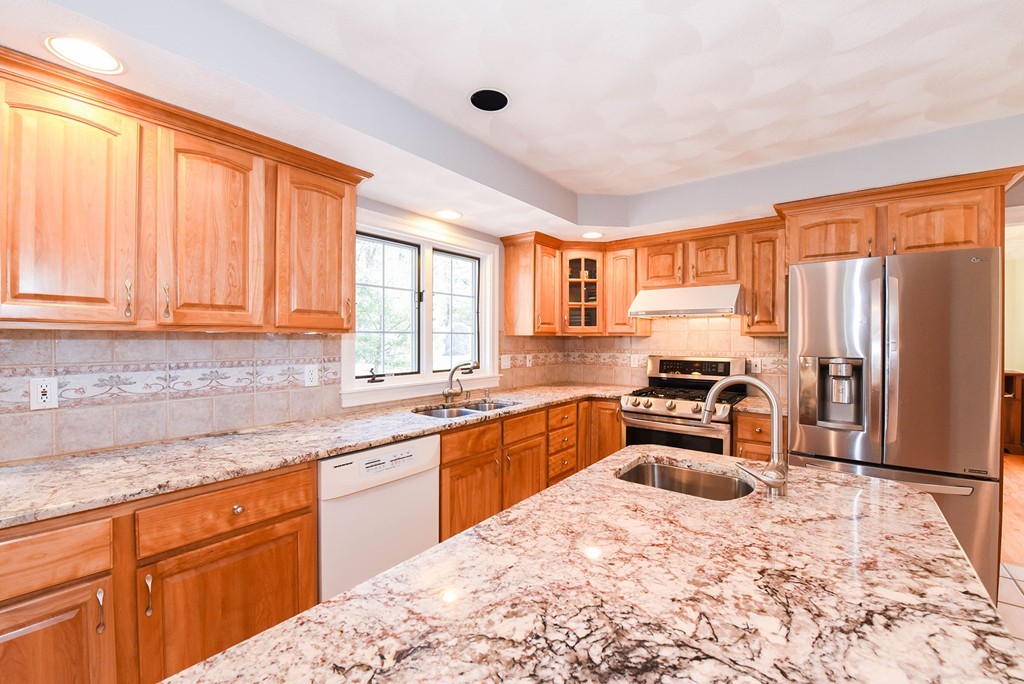 244 Hayden Road Groton, MA 01450 - Photo 5 of 23 a kitchen with stainless steel appliances granite countertop a sink stove and refrigerator