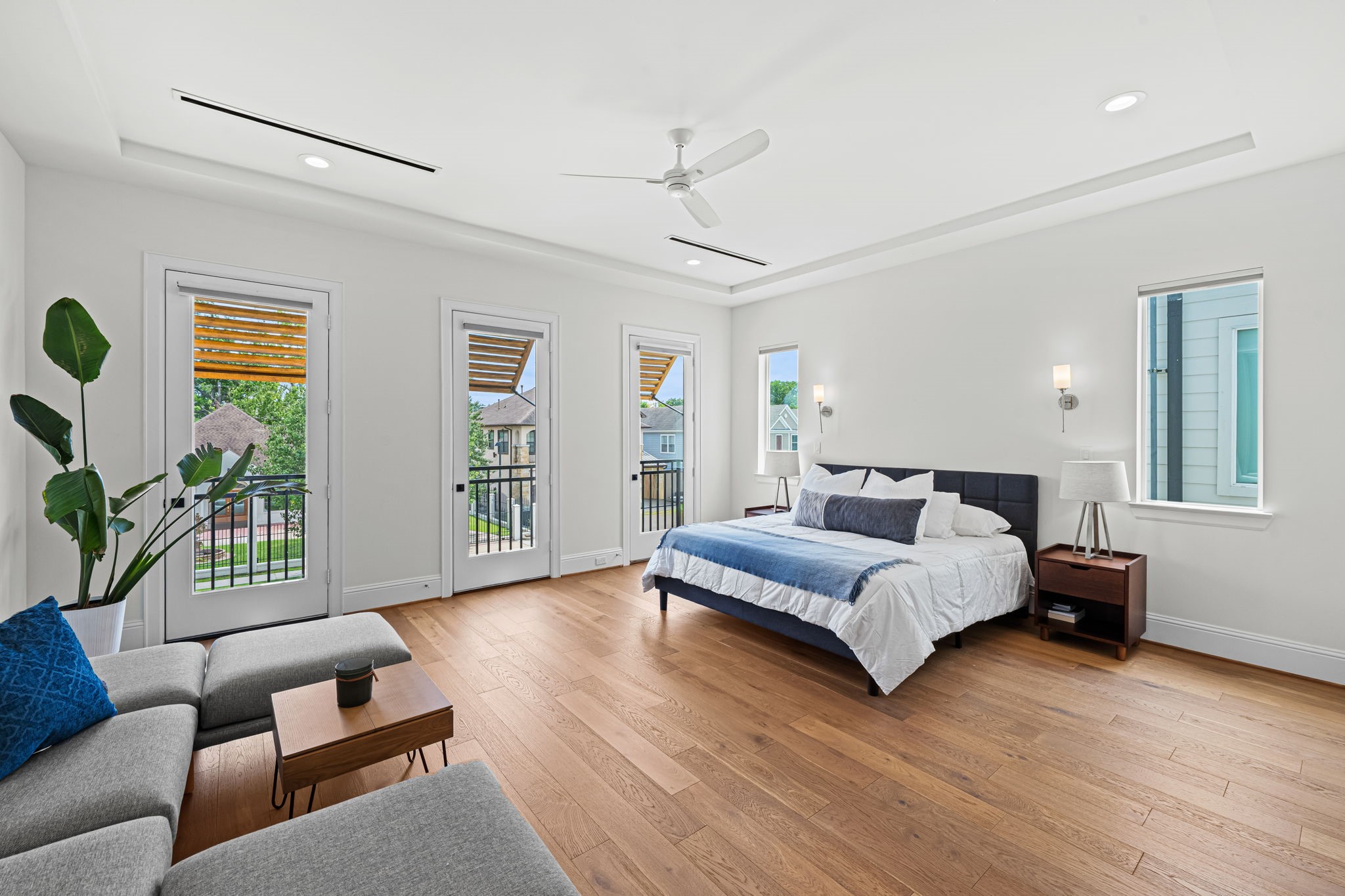 533 West 27th Street Houston, TX 77008 - Photo 12 of 22 Designed as a true retreat, the oversized primary suite features wood flooring, abundant windows, and triple doors opening to Juliet balconies.