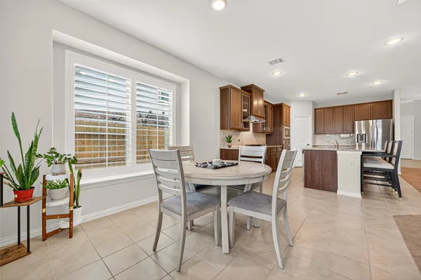 a large kitchen with stainless steel appliances granite countertop lots of counter top space and a center island