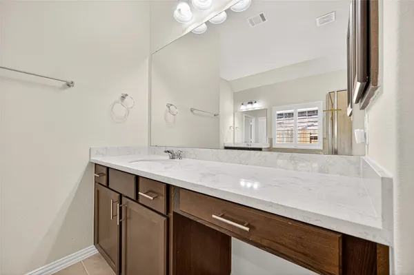 a bathroom with a window and a shower