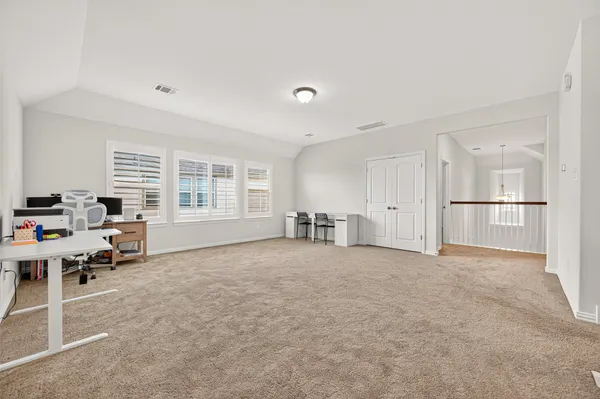 a spacious bathroom with a tub sink and mirror