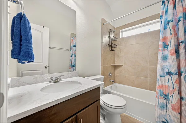 a bedroom with a bed and ceiling fan