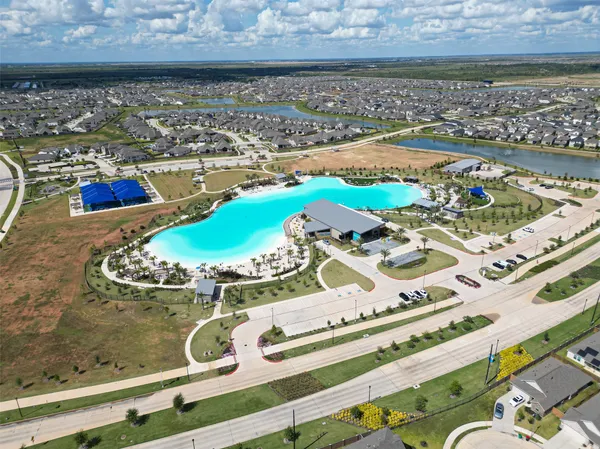 an aerial view of a house with a yard and lake view