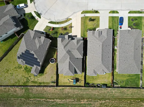 an aerial view of residential houses with outdoor space