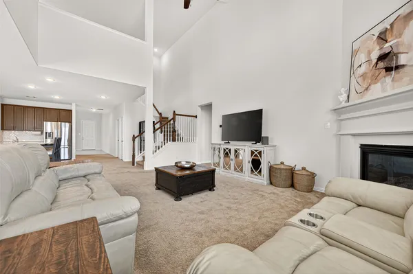 a large kitchen with stainless steel appliances granite countertop a stove a sink and a refrigerator