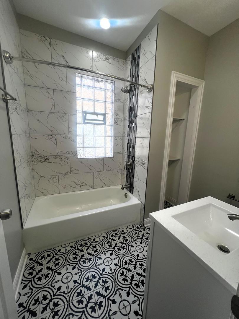 3257 West Warren Boulevard, Unit 2 Chicago, IL 60624 - Photo 11 of 21 a bathroom with a bathtub and a shower