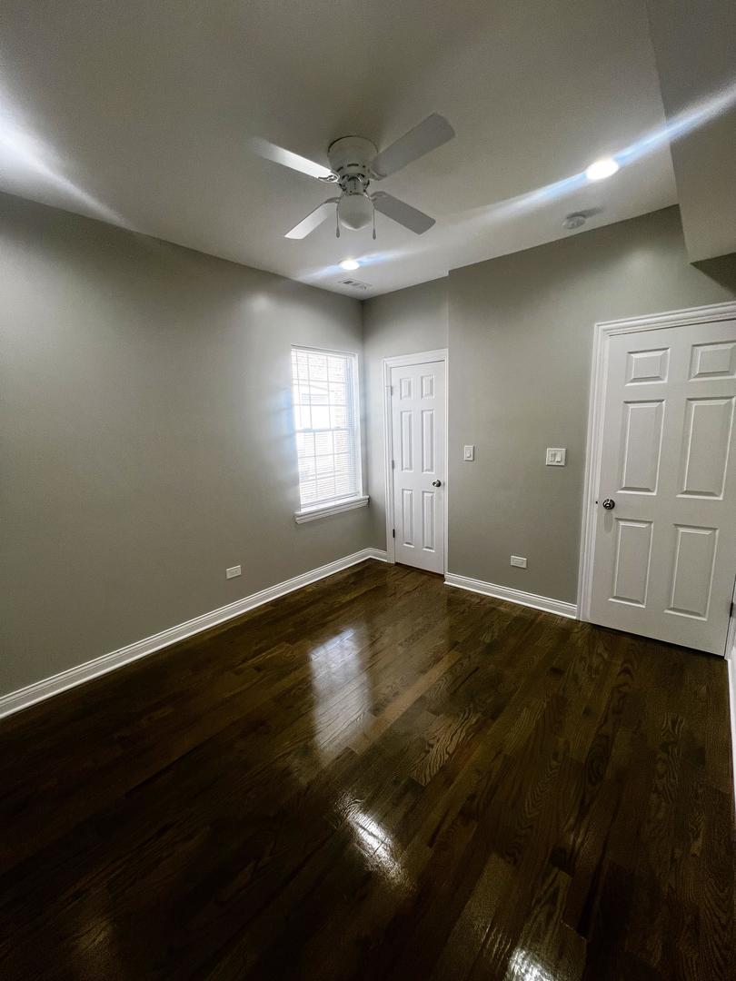 3257 West Warren Boulevard, Unit 2 Chicago, IL 60624 - Photo 12 of 21 an empty room with wooden floor and windows
