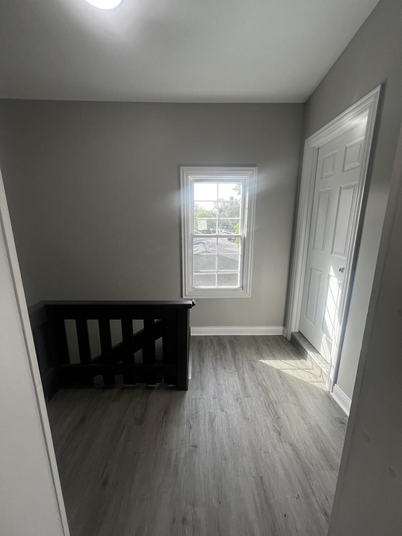 3257 West Warren Boulevard, Unit 2 Chicago, IL 60624 - Photo 20 of 21 an empty room with wooden floor and windows