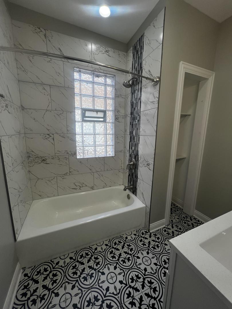 3257 West Warren Boulevard, Unit 2 Chicago, IL 60624 - Photo 9 of 21 a bathroom with a bathtub and a shower