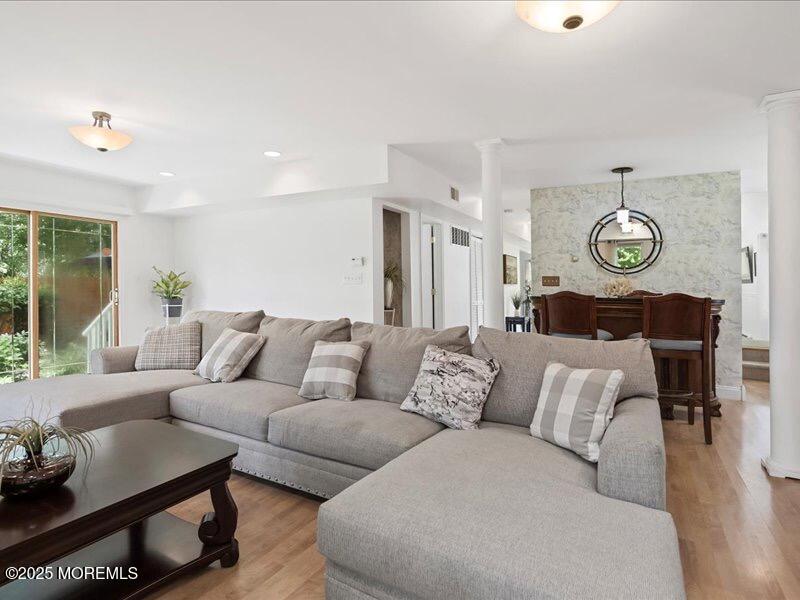 552 Prospect Avenue Spring Lake Heights, NJ 07762 - Photo 11 of 25 a living room with furniture a clock and a large window