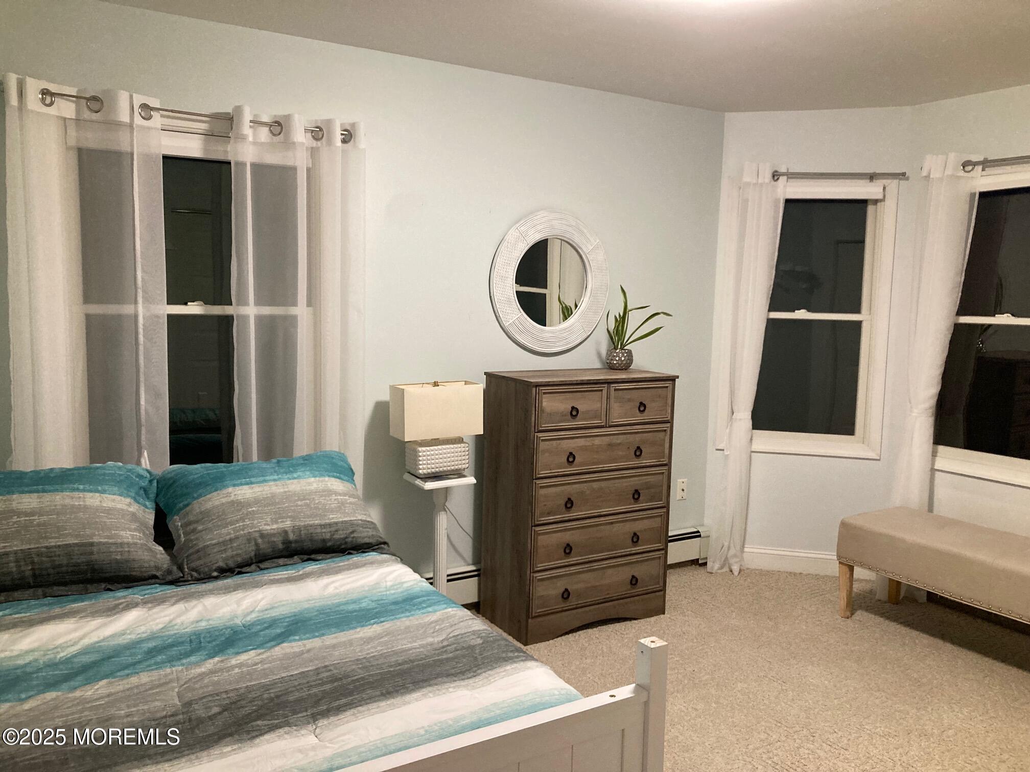 552 Prospect Avenue Spring Lake Heights, NJ 07762 - Photo 14 of 25 a spacious bedroom with a bed and a dresser