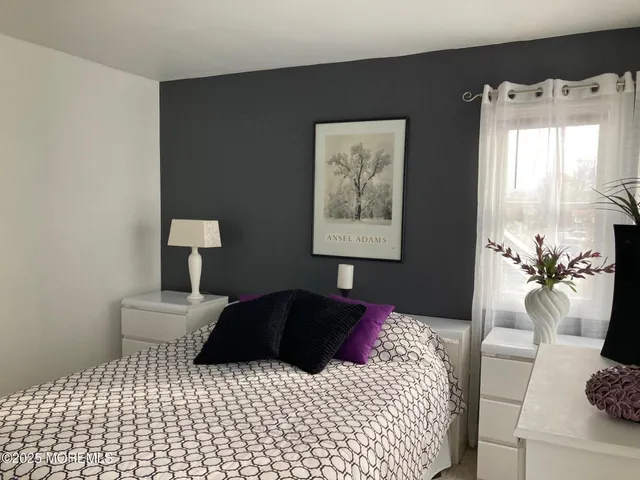 a bedroom with a bed and a lamp