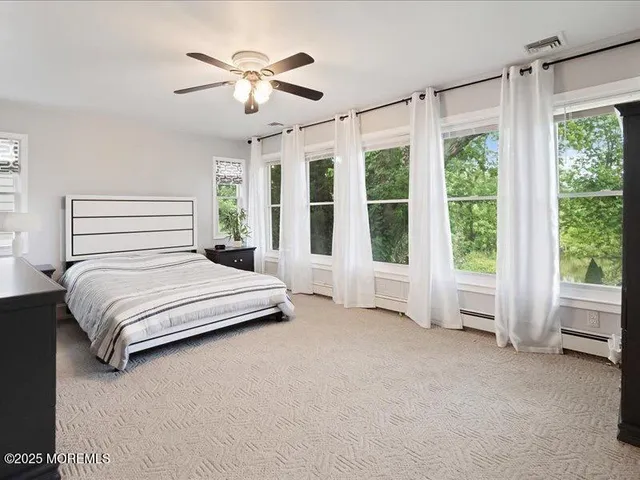 a bedroom with a large bed and a large window