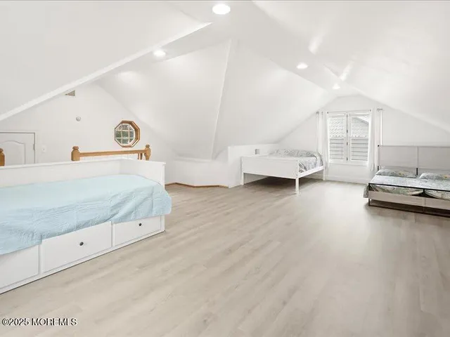 a view of a bedroom with furniture and window