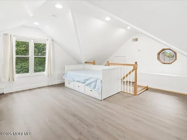 a spacious bedroom with a bed and a window