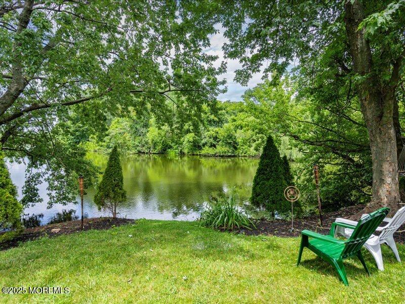 552 Prospect Avenue Spring Lake Heights, NJ 07762 - Photo 25 of 25 a backyard of a house with a garden and lake view