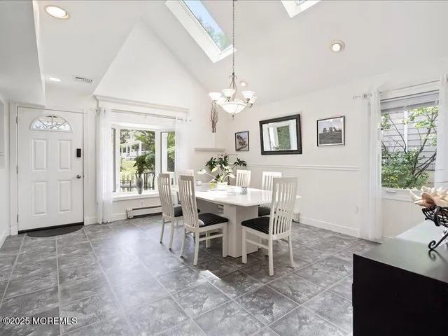 a view of a dining room with furniture and window