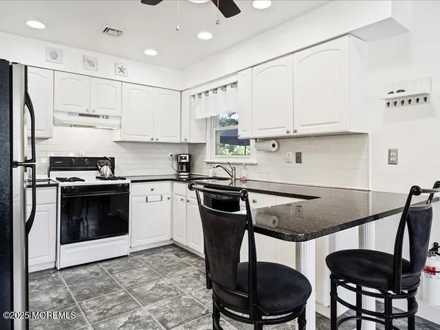 a kitchen with a stove a sink and a refrigerator