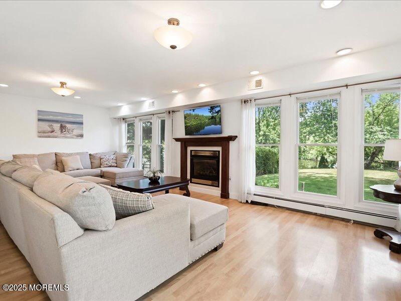 552 Prospect Avenue Spring Lake Heights, NJ 07762 - Photo 10 of 25 a living room with furniture large window and a fireplace