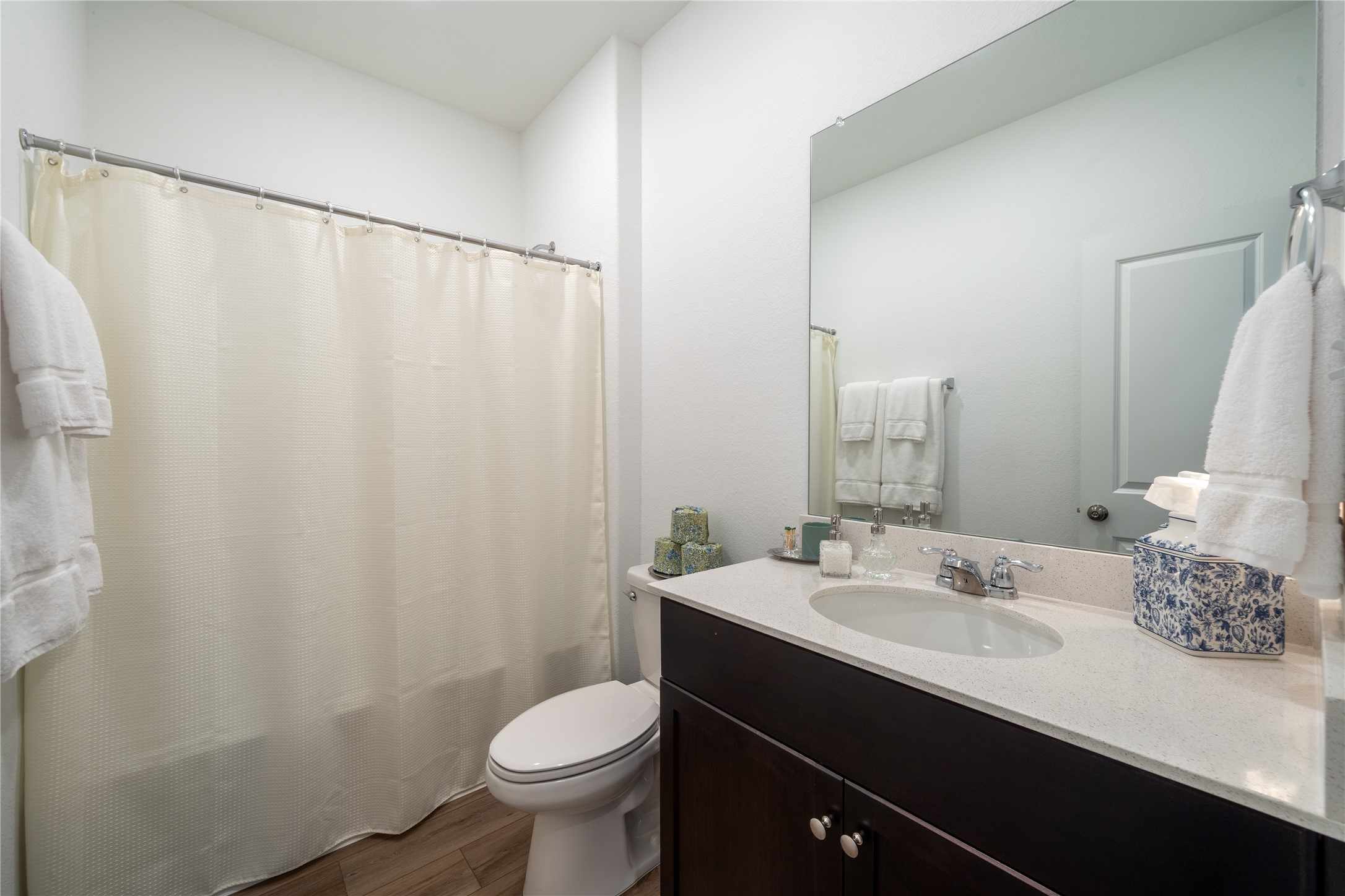 14404 Berning Road Manor, TX 78653 - Photo 30 of 38 A well-lit bathroom with a vanity and a shower-tub combination.