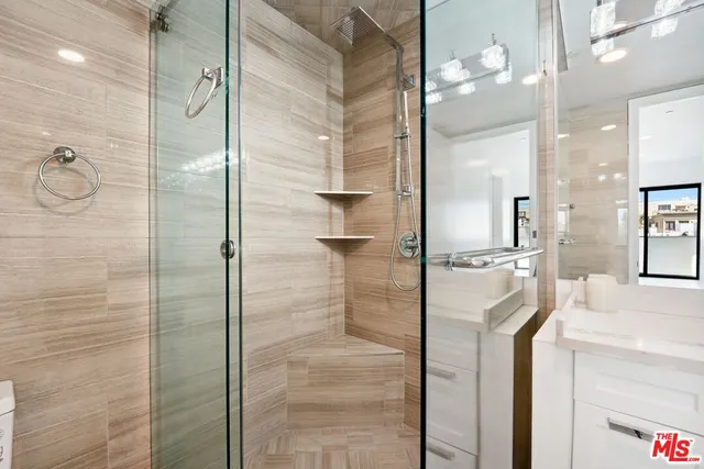 a bathroom with a shower and a sink