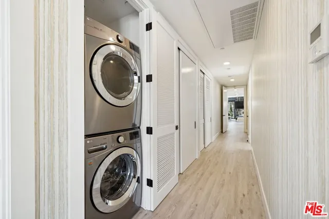 a view of a hallway with washer and dryer