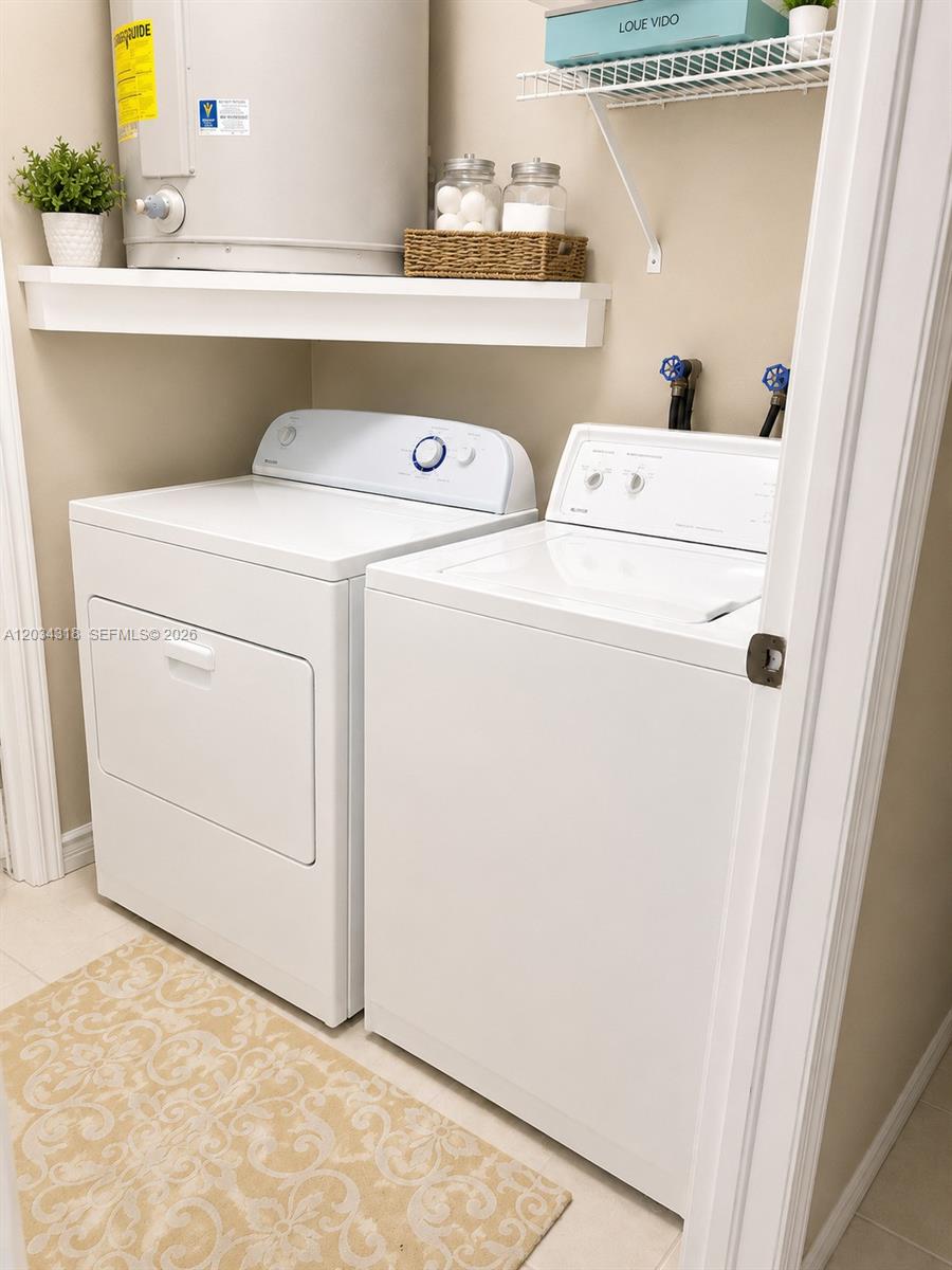 14856 Southwest 179th Street Miami, FL 33187 - Photo 30 of 33 a utility room with dryer and washer