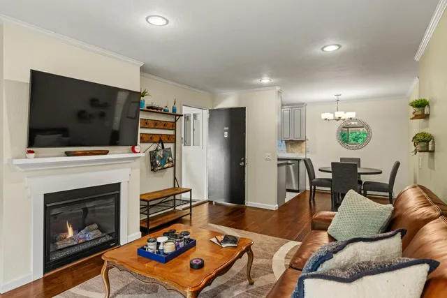 a living room with furniture a flat screen tv and a fireplace
