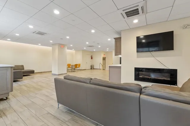 a view of a kitchen with refrigerator and windows