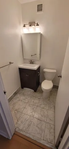 an empty room with chandelier fan