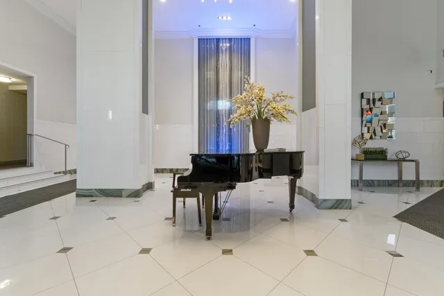 a dining room filled with furniture and a chandelier