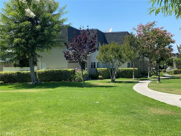 a view of a garden with a building in the background